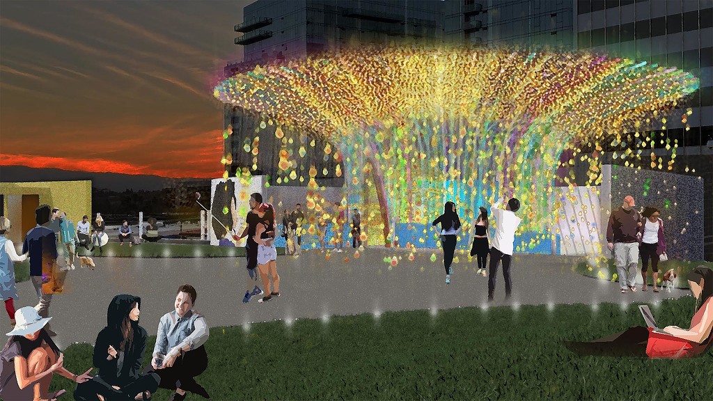 A group of people in a large room with a large display of flowers.